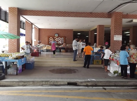 Customers look over products on sale outside Pattaya City Hall.